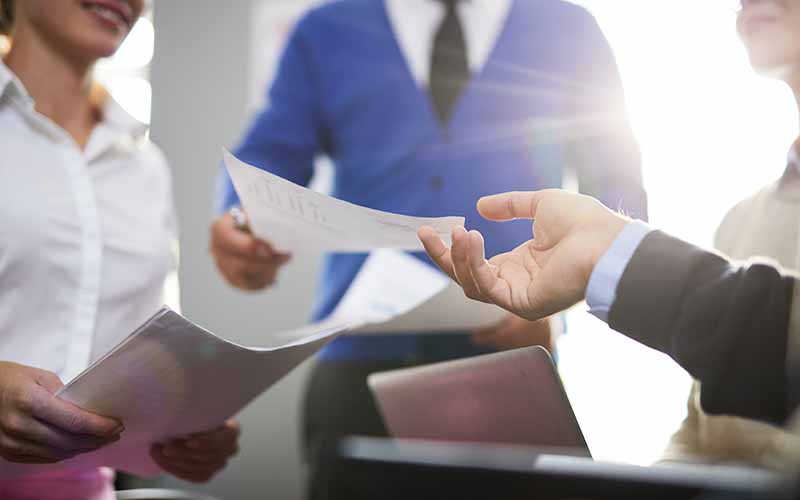 Handing documents to desk clerk
